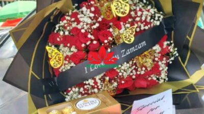 Red roses, gypsophila bouquet and ferrero chocolate
